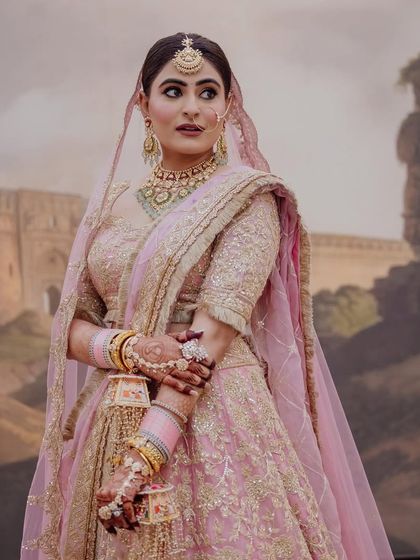 A portrait from my wedding day, feeling every bit the bride in a beautiful pink lehenga.