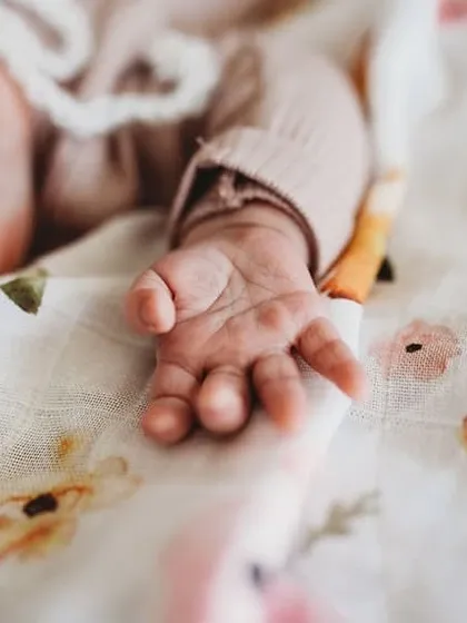 It is all about the tiny details. A close-up of a newborn's hand shows just how small and precious they are. We make sure to capture these details during our newborn photography sessions.
