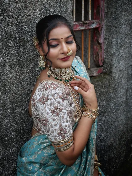 The detailed embroidery on the blouse sleeve is the star of this close-up shot.