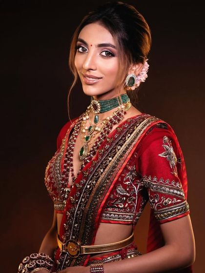 A smiling bride in a red lehenga. Learn to create looks that radiate happiness and confidence. Enroll in my Delhi pro batch.