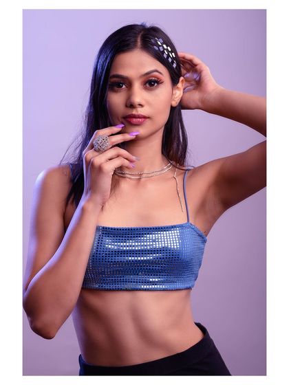 A fun and energetic studio shot with creative lighting. The pose and accessories give this portrait a modern, pop-inspired vibe.
