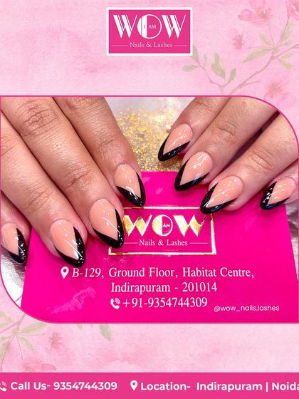 A modern and edgy design featuring a nude base with sharp, graphic black V-tips. This minimalist look is perfect for a chic and powerful statement.