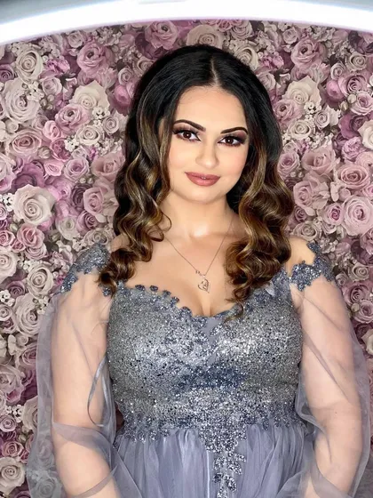 This shot, taken with a ring light, shows the perfection of the reception makeup. The highlights on her cheekbones and the inner corner of her eyes catch the light beautifully.