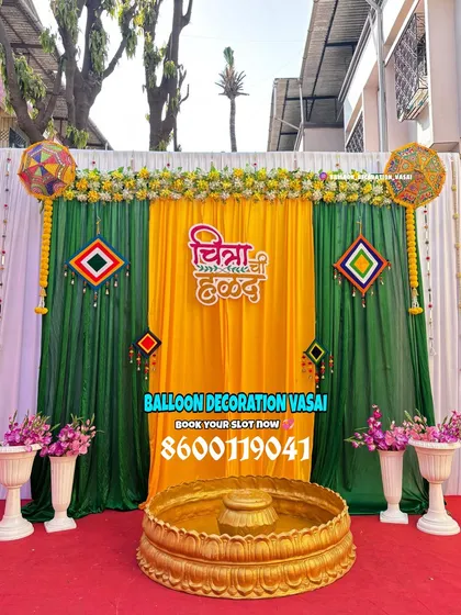 For a traditional Haldi ceremony, we use a classic combination of yellow and green drapes, marigold flowers, and personalized signage in Marathi for an authentic touch.