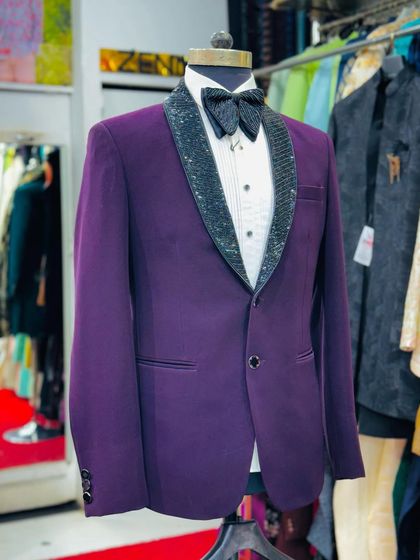 A purple tuxedo with a sparkling black sequined lapel. This is a perfect party outfit, combining a rich color with a touch of glamour.