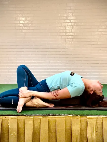 Supta Virasana, or Reclined Hero Pose, is a deep stretch for the quadriceps and hip flexors. It embodies 'Yutori,' the Japanese concept of finding balance in the calm and making space for relaxation.
