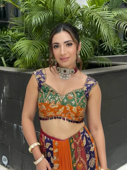 A close-up of one sister's makeup, featuring a soft brown smokey eye and a neutral lip, which works perfectly with her multi-colored blouse.