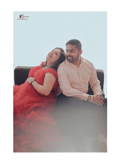 A candid, joyful moment captured during a maternity shoot. The mom-to-be is wearing a beautiful red ruffled gown, showing how my dresses are comfortable enough for relaxed and happy poses.