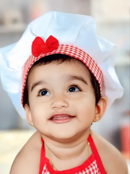 This close-up from our 'Little Chef' theme captures the pure delight and curiosity of a child. We focus on bright eyes and happy smiles to create portraits that are full of life and personality.
