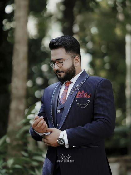 The groom adjusting his cufflinks, a classic shot that captures the final touches of getting ready for his wedding day.