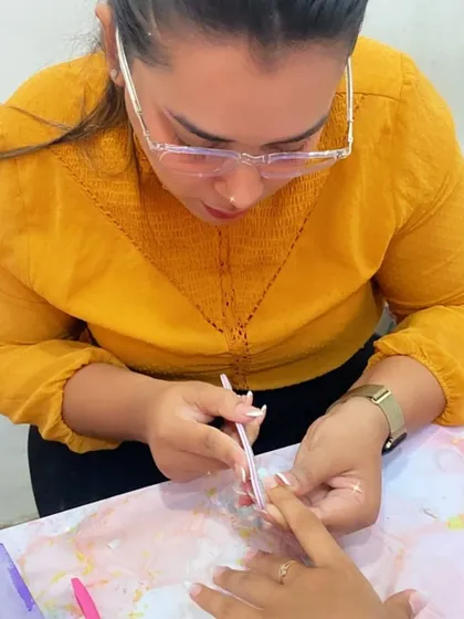 A student practices applying an extension, focusing on the foundational steps that ensure a long-lasting result.