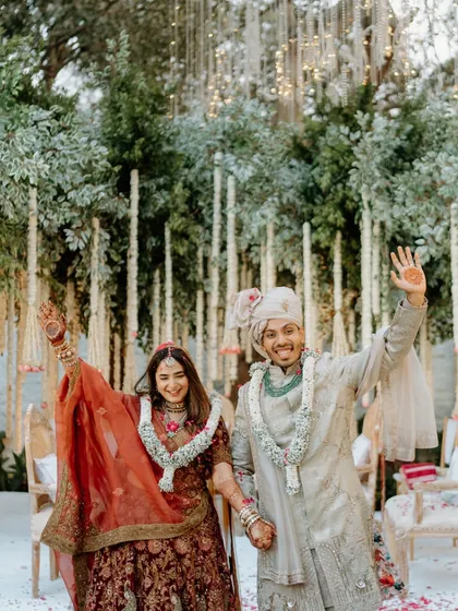 The happy couple waves to their guests after the ceremony. This image is full of positive energy and marks the official start of their new life together.
