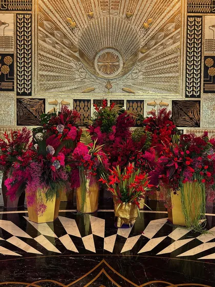 I was ecstatic to create the first lobby installation for the stunning Fairmont Mumbai. I used bold red and magenta florals in golden vases to complement the hotel's opulent art deco interiors, creating a dialogue between my art and the architecture.