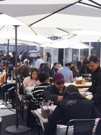 The bustling atmosphere at our pop-up restaurant at the India Art Fair. Our outdoor seating area is always a popular spot for visitors to relax and refuel.
