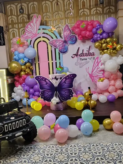 A wider view of the butterfly birthday setup, which also included a mini toy jeep for the birthday girl's grand entrance.