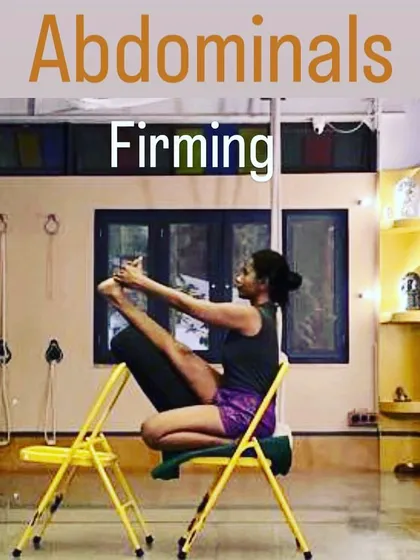 This is a variation of Navasana (Boat Pose) using two chairs for support. This setup helps to isolate and engage the abdominal muscles for firming and toning, while also working on hamstring flexibility and spinal length.