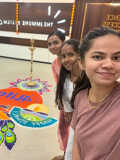 A happy moment with my team after completing a large rangoli for a corporate client. It's always rewarding to see the finished piece in its intended space.