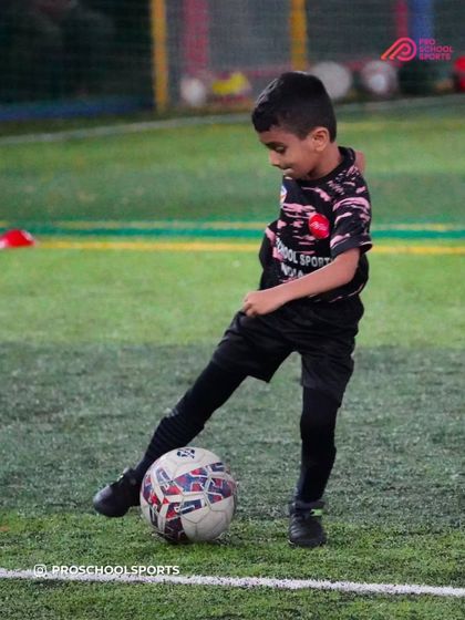 A smile on the face of a young player as they practice their kicking technique.