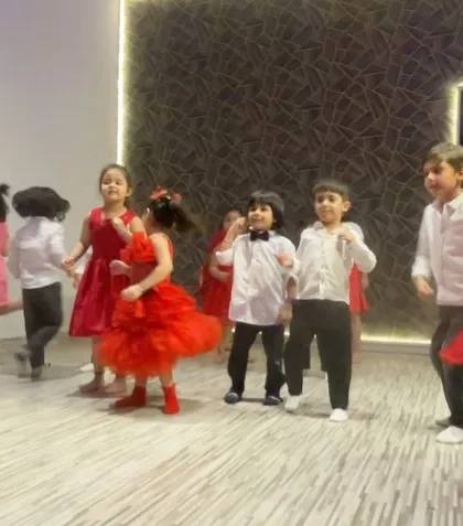 Our little performers all dressed up in red and white for a special group dance. Themed outfits just add to the fun and make them feel like professional artists on stage.