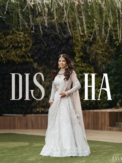 A beautiful portrait of the bride in her elegant off-white lehenga, with her name "DISHA" artistically placed. A modern and personalized take on the classic bridal shot.