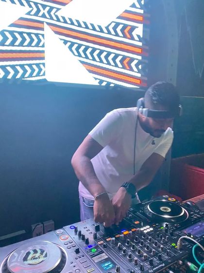 A close up of my hands adjusting the levels on the mixer, a key part of the DJing craft.