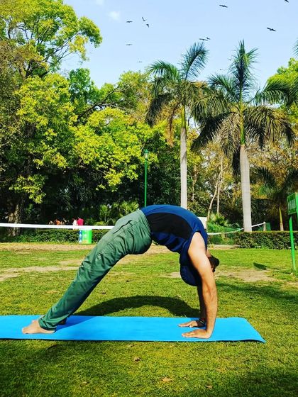 The classic Urdhva Dhanurasana or Wheel Pose, practiced outdoors. This energizing backbend is a staple in our classes for building spinal flexibility.