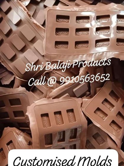 This image shows a bulk order of custom chocolate molds, each designed to imprint a brand's logo. This is how you can scale up production for branded chocolates or soaps.