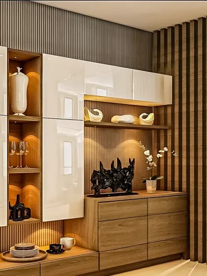 This custom crockery and bar unit features a mix of high-gloss white cabinets and wood drawers. We used vertical wood slats and integrated lighting in the open shelves to highlight decorative items.