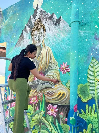 Working on the robes and posture of the Buddha figure.