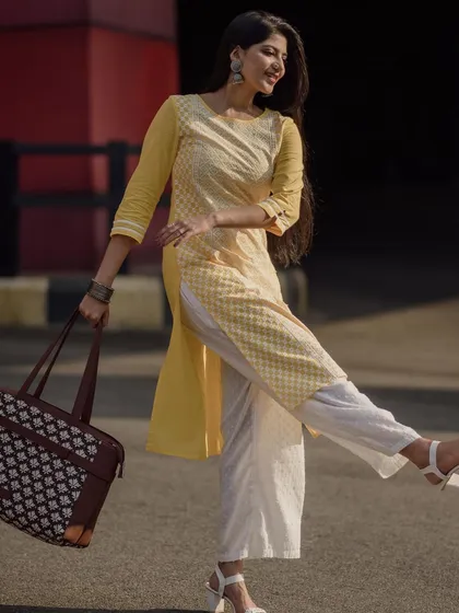 Modeling for a modern Indian brand, this look is about effortless daily style. I am wearing a comfortable yellow and white kurti set, paired with a handcrafted tote bag, perfect for a day out in the city.