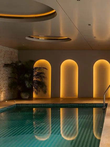 This basement pool area was designed as an unexpected, indulgent escape. The warm glow from the arched niches reflects on the water, creating an immersive retreat that feels both modern and timeless.