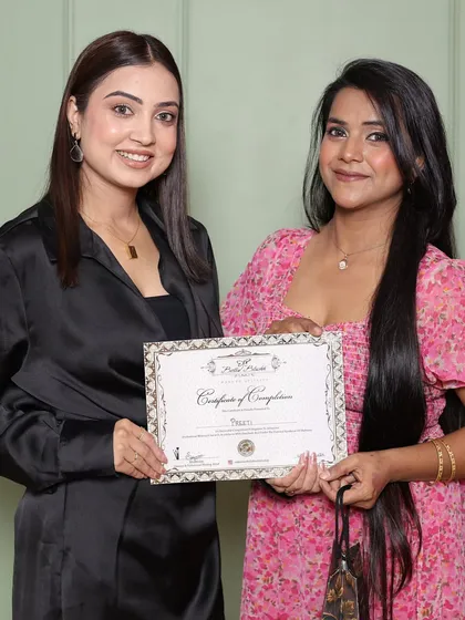 A happy student on her certification day. The one-month journey transforms them into professional makeup artists.