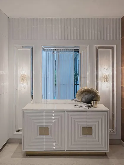 This beautiful credenza stands pretty, hides the chaos, and demands a second look. The piece features a geometric, fluted design on the doors with custom square brass handles, creating a piece of functional art.