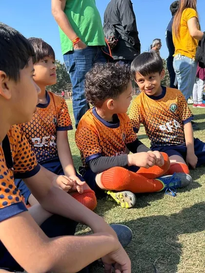 Teammates chatting on the sidelines. These moments of camaraderie are essential for building a strong team bond.