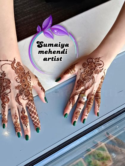 A full view of the party henna on both hands, showing the asymmetrical designs.