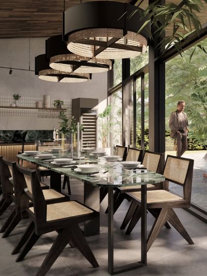 The dining area render for 'Kasu Vaha' is a space designed for connection, featuring a large eight-seater table under dramatic pendant lights, with a full view of the garden.