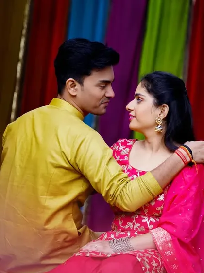 An intimate gaze shared between the couple, surrounded by colorful marigold garlands. This pre-wedding shot beautifully blends tradition and romance.