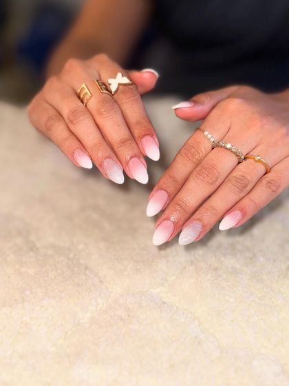 A beautiful baby boomer ombre on almond-shaped nails. The seamless blend from pink to white is a technique that requires skill and practice.