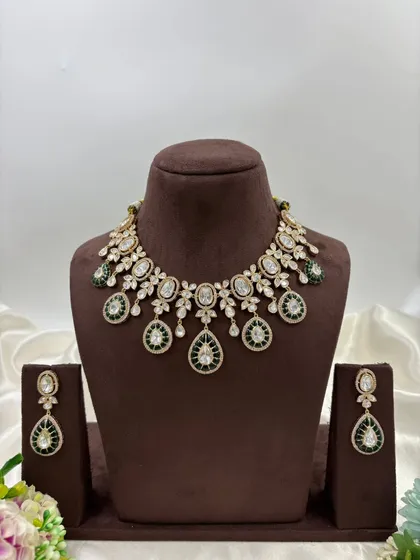 The full view of the polki necklace with green meenakari drops.