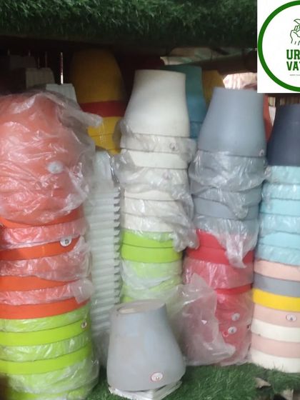A variety of plastic pots in different shapes and pastel colours.