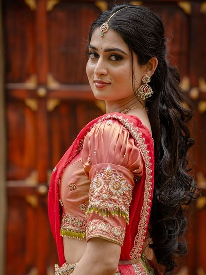 A close-up of Moksha's beautiful half-ponytail hairstyle and soft, glowing makeup.