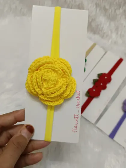 This headband features a beautifully detailed yellow crochet rose on a matching yellow nylon band.