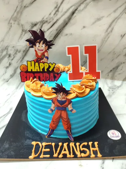 It's over 9000! A Dragon Ball Z cake for an 11th birthday, featuring Goku ready for action. The bright blue and orange design makes it super eye-catching.