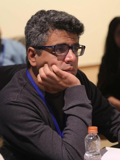 A participant deeply engrossed in thought during our workshop with Nandana Sen. We create spaces for serious reflection and creative learning.