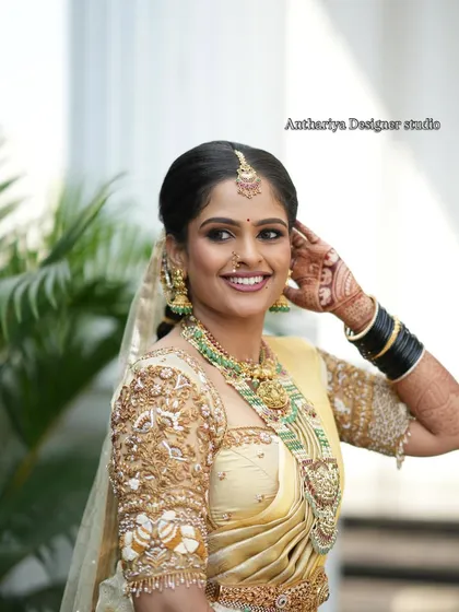 Seeing our bride Monisha glowing with happiness is why I do what I do. We designed this custom golden Kanjivaram blouse to match her wedding saree, focusing on heavy embroidery to create a look of pure grace.