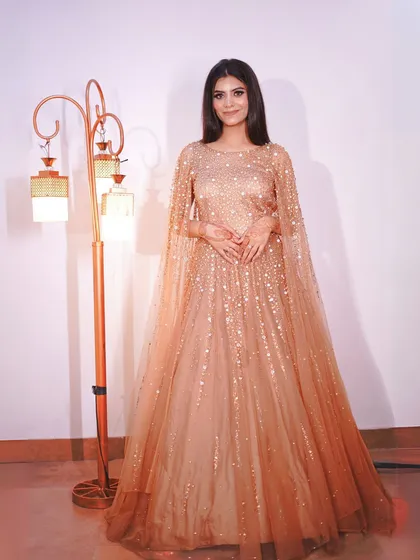 A classic full-length pose in this stunning golden cape gown.