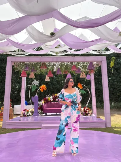 A wide shot showing the beautiful purple and white drapes and the whimsical decor of the carnival stage.