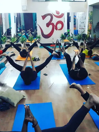 A synchronized moment of core strengthening and leg stretching. This pose challenges balance and builds abdominal strength, essential for a stable yoga practice.