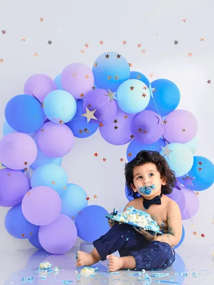 A messy and happy two-year-old enjoying his birthday cake. Our cake smash sessions are all about capturing the fun and personality of your toddler.