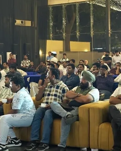 An engaged audience of industry professionals at a corporate tech summit. We manage the audio and visual production for conference settings, ensuring presentations are delivered with clarity.